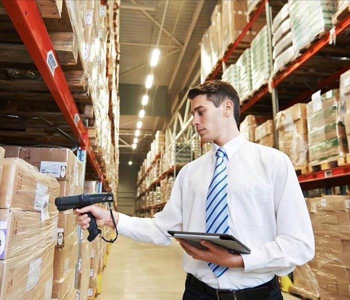 Man scanning inventory in warehouse